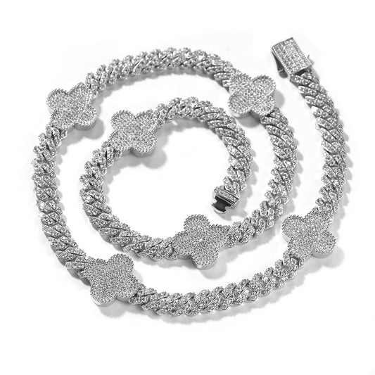 Silver chain necklace with floral designs on a white background